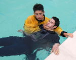 RESCUES, CASUALTY, UNCONSCIOUS, TOW, 2 RESCUE BREATHING
Support the casualty for poolside resuscitation and do not touch the throat 4